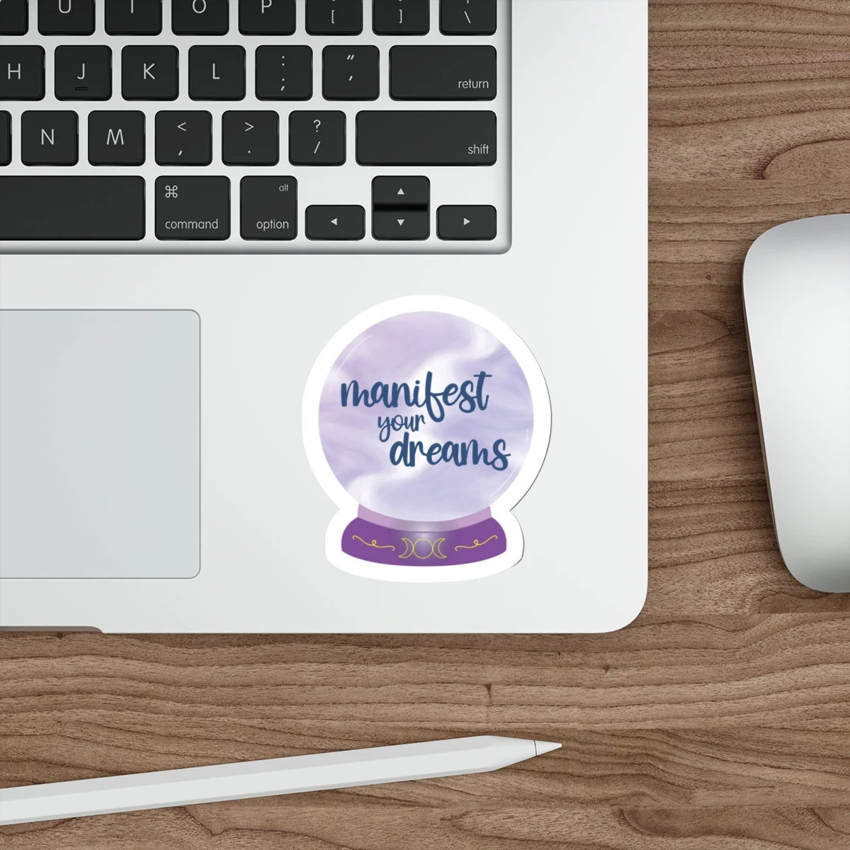 Manifest your dreams purple crystal ball sticker on a laptop