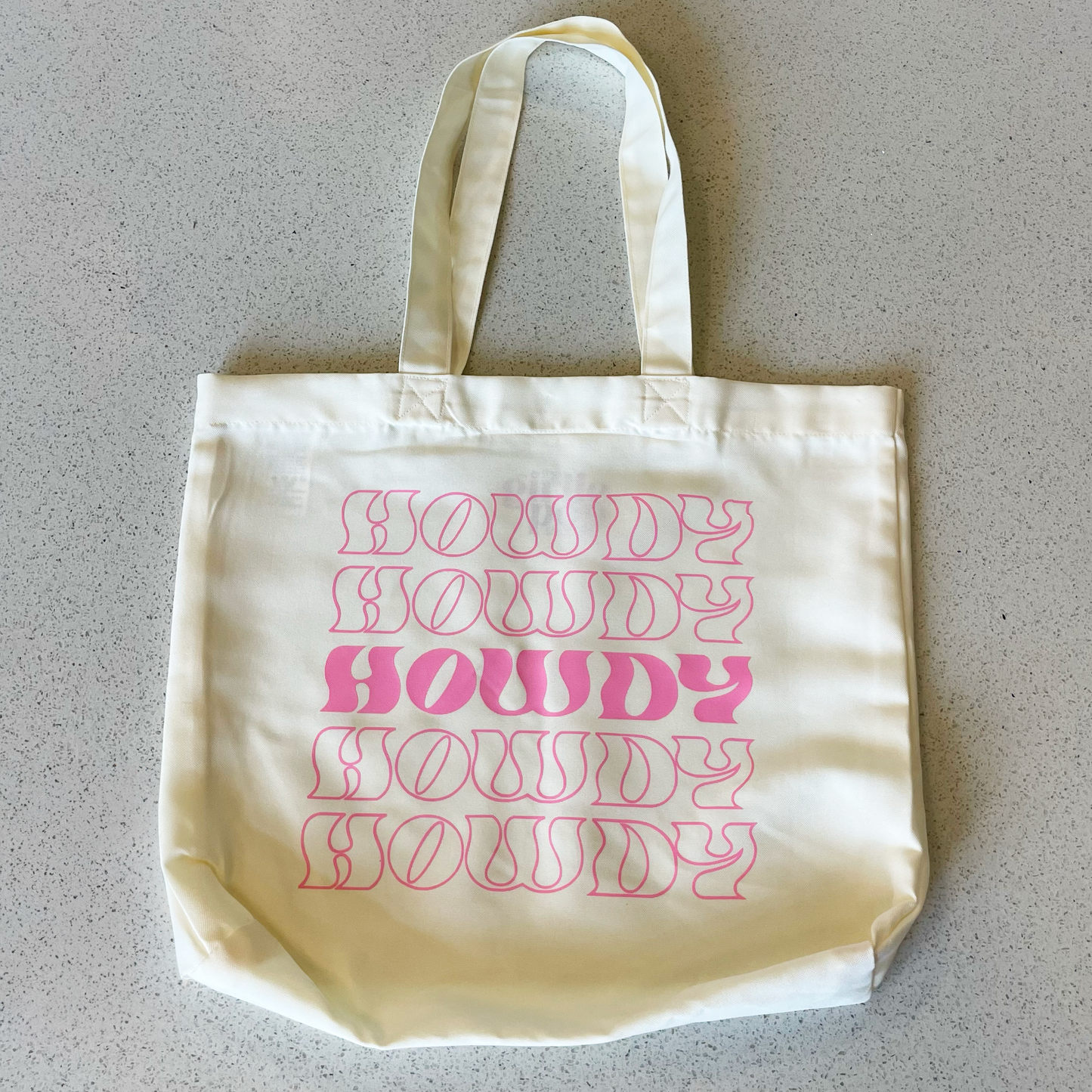 tote bag that says howdy in pink