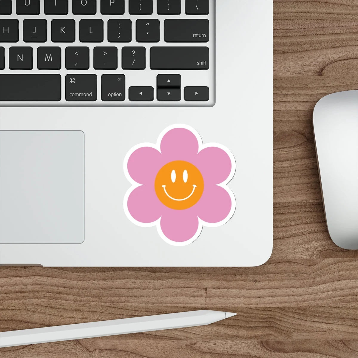 pink and orange groovy flower smiley face on a laptop
