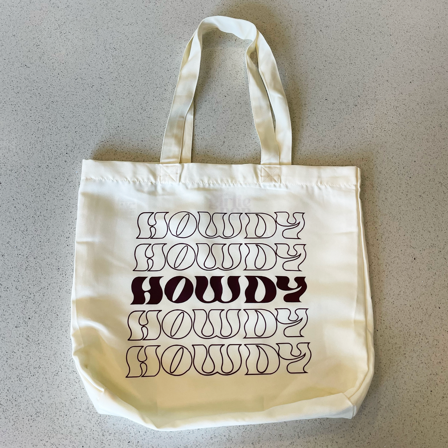 tote bag that says howdy in wine red