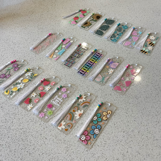 acrylic bookmarks laid out on a table