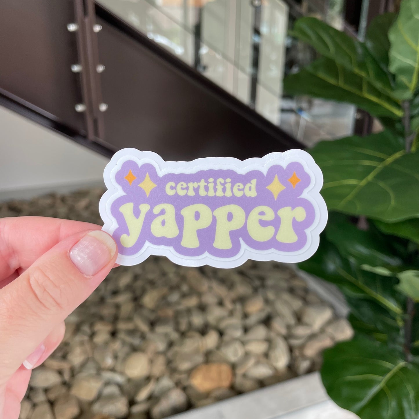 purple and yellow sticker with sparkles that says certified yapper