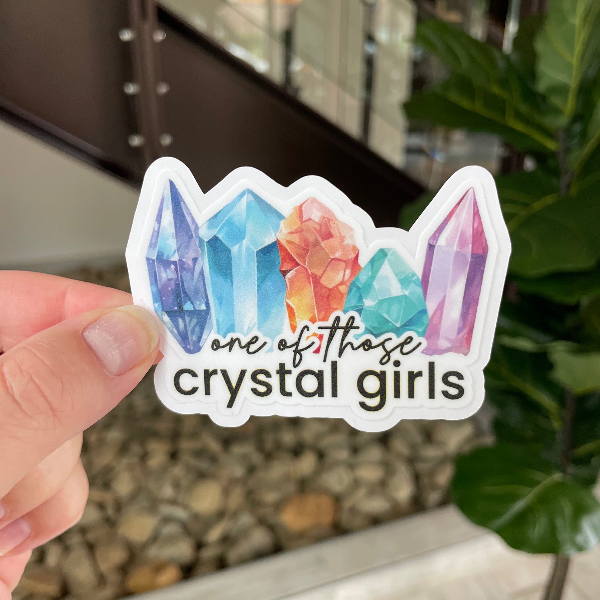 sticker with multicolored crystals that says "one of those crystal girls"