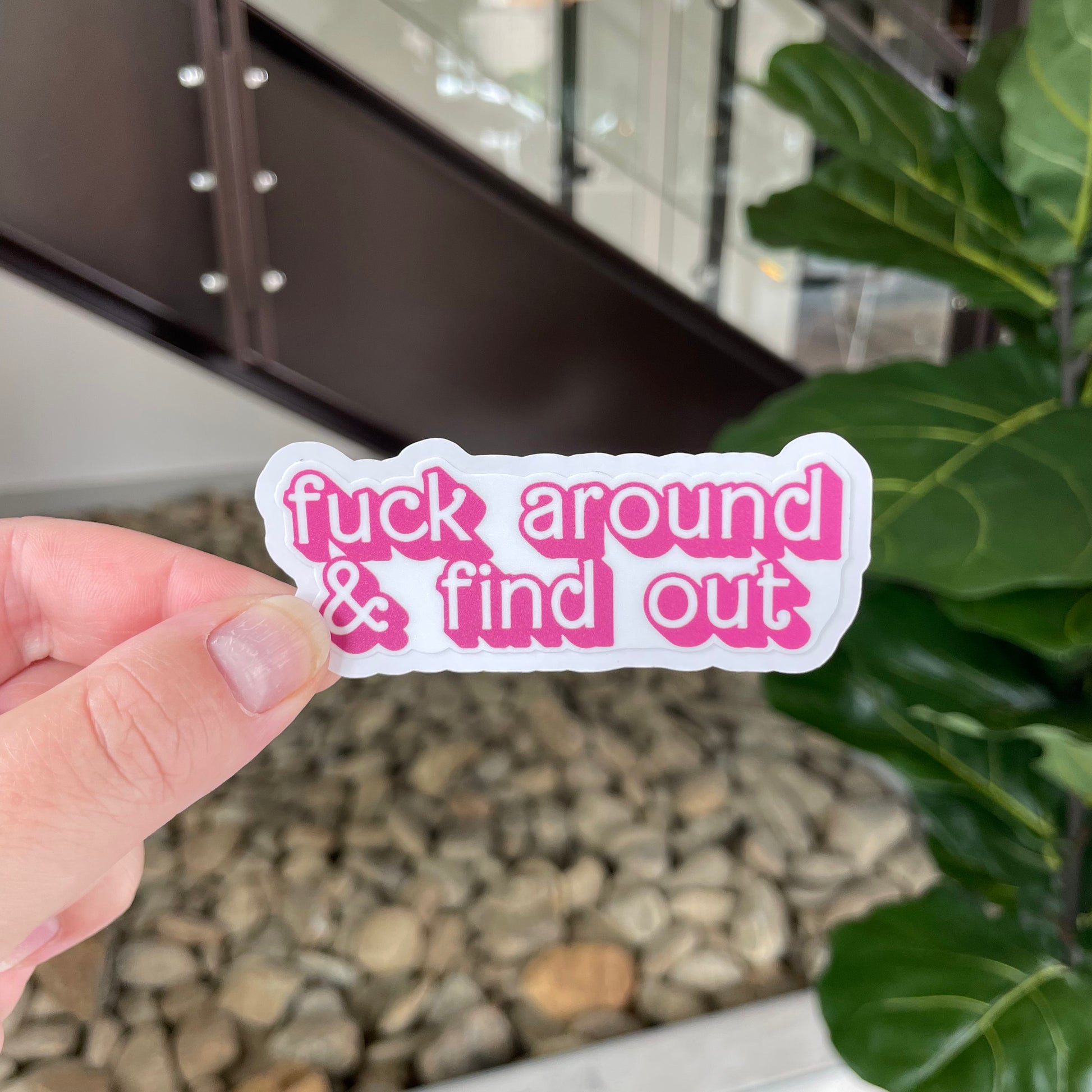 sticker in pink barbie-like font that says "fuck around and find out"