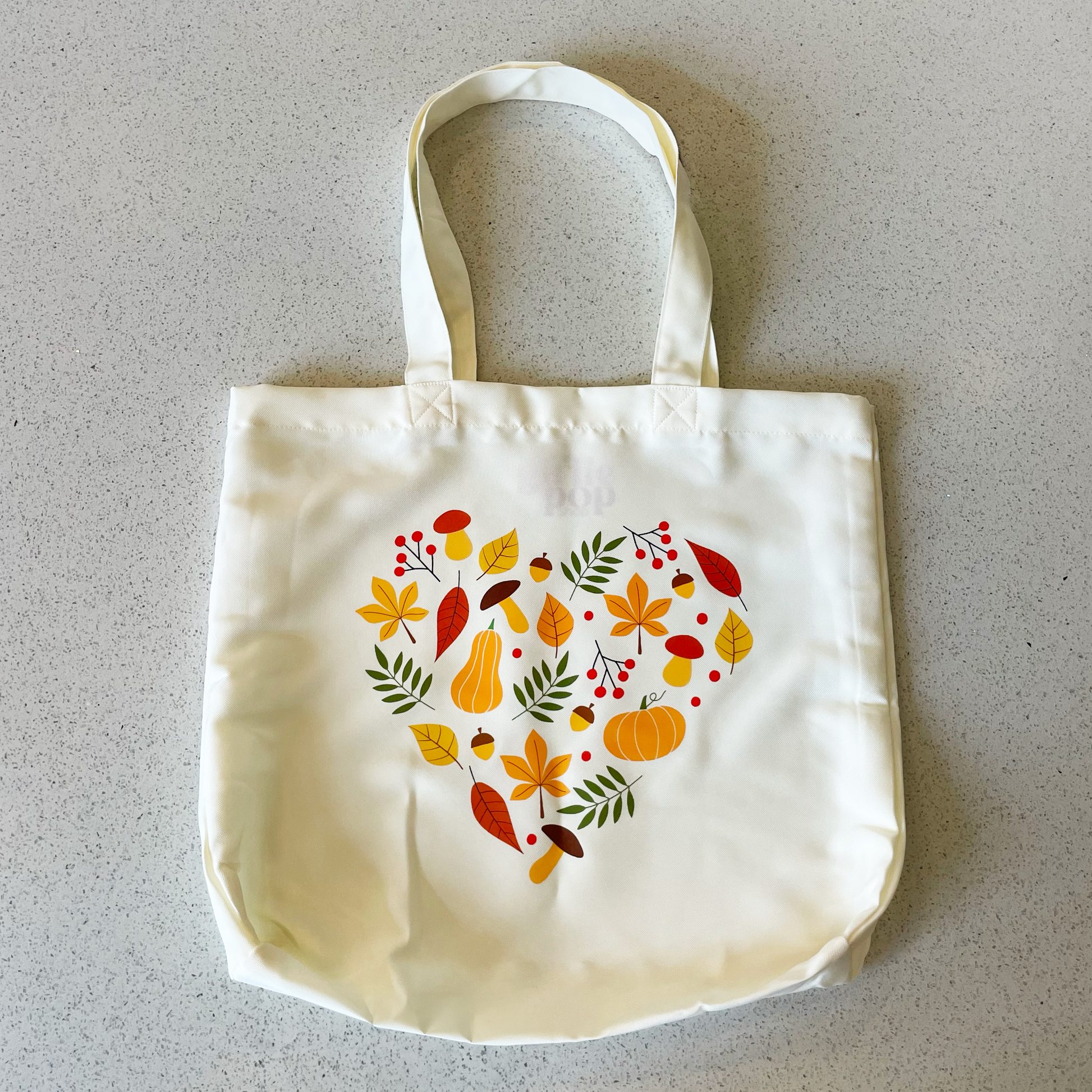 fall heart tote bag laying on table