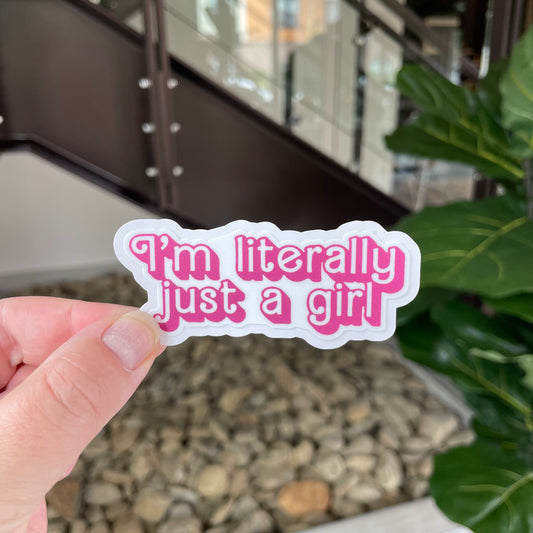 sticker in pink barbie-like font that says "i'm literally just a girl"