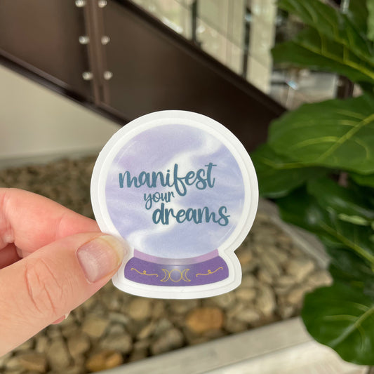 purple crystal ball that says manifest your dreams